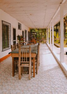Cozy terrace featuring wooden dining set on tiled floor, perfect for outdoor gatherings.